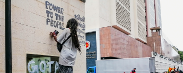Sri Lanka protestor graffitis 'power to the people'